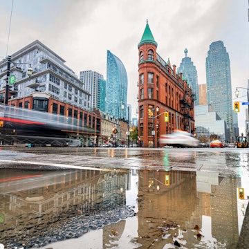The Gooderham Building (Flatiron), a Romanesque style building, in East Toronto on a rainy day in the Financial District.